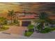 Sunset view of mediterranean home with two car garage, tile roof, and brick driveway at 362 41St Ave, St Pete Beach, FL 33706