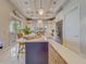 Bright, modern kitchen with an island, pendant lighting, stainless steel appliances, and pantry at 362 41St Ave, St Pete Beach, FL 33706