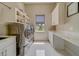 A bright laundry room with modern appliances, storage and sink at 362 41St Ave, St Pete Beach, FL 33706
