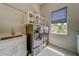 This laundry room features modern appliances, storage and a utility sink at 362 41St Ave, St Pete Beach, FL 33706