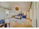 Bright main bedroom with a luxury bed, a sitting area, and a decorative ceiling fan, perfect for relaxation at 362 41St Ave, St Pete Beach, FL 33706