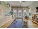 Bright home office with leafy wallpaper, water view, desk, chair, and cozy seating area at 362 41St Ave, St Pete Beach, FL 33706