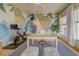 Bright home office with custom leaf-themed wall, desk, exercise bike and comfy poufs at 362 41St Ave, St Pete Beach, FL 33706
