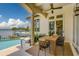 Relax and unwind on this spacious covered lanai with outdoor dining, bay access, and a pool at 362 41St Ave, St Pete Beach, FL 33706