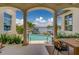 Outdoor living at its finest, a poolside oasis featuring covered seating and dining area with water views at 362 41St Ave, St Pete Beach, FL 33706