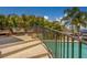 This poolside patio boasts lush landscaping, an intimate seating area, and a sleek metal railing at 362 41St Ave, St Pete Beach, FL 33706
