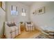 Cozy sitting area with striped chairs, natural light, and decorative artwork, perfect for relaxing and unwinding at 362 41St Ave, St Pete Beach, FL 33706