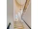 Staircase with a contemporary chandelier and large windows providing natural light, enhancing the architectural details at 362 41St Ave, St Pete Beach, FL 33706