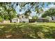 Spacious backyard featuring a screened-in pool area, offering privacy and relaxation at 3802 Cloverhill Ct, Brandon, FL 33511