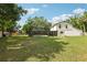A view of a large backyard, a screened in pool area, and lots of green space at 3802 Cloverhill Ct, Brandon, FL 33511