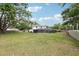 Large backyard view with a screened-in pool, providing ample space for outdoor enjoyment at 3802 Cloverhill Ct, Brandon, FL 33511