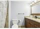 Bathroom features a toilet, vanity, and framed mirror, complete with neutral finishes at 3802 Cloverhill Ct, Brandon, FL 33511
