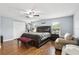 Bedroom featuring hardwood floors, a ceiling fan, a large bed and ample natural light at 3802 Cloverhill Ct, Brandon, FL 33511