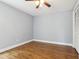Vacant bedroom showcases wood floors, a ceiling fan, and a closet for ample storage at 3802 Cloverhill Ct, Brandon, FL 33511