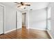 Empty bedroom with hardwood floors, closet, ceiling fan, and a doorway leading to another room at 3802 Cloverhill Ct, Brandon, FL 33511