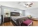Bedroom featuring hardwood floors, ceiling fan, and a large bed with decorative pillows and side tables at 3802 Cloverhill Ct, Brandon, FL 33511