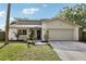 Charming home with a two-car garage, well-kept lawn, and mature landscaping at 3802 Cloverhill Ct, Brandon, FL 33511