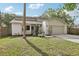 Inviting home featuring a two-car garage, a manicured lawn, and well-placed landscaping at 3802 Cloverhill Ct, Brandon, FL 33511