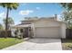 Beautifully maintained home with a two-car garage, well-kept lawn, and mature trees at 3802 Cloverhill Ct, Brandon, FL 33511