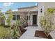 Inviting front entrance with a covered porch, mature landscaping, and a modern front door at 3802 Cloverhill Ct, Brandon, FL 33511
