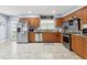 Bright kitchen features stainless steel appliances, granite counters, and wood cabinets at 3802 Cloverhill Ct, Brandon, FL 33511