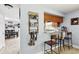 A view of a kitchenette with bar seating, cabinets, and stainless appliances at 3802 Cloverhill Ct, Brandon, FL 33511