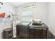 A functional laundry room with washer, dryer, water heater, and storage space at 3802 Cloverhill Ct, Brandon, FL 33511