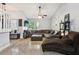 Spacious living room featuring a large sectional sofa, tile flooring, and a ceiling fan at 3802 Cloverhill Ct, Brandon, FL 33511