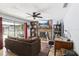 Comfortable living room with a brick fireplace, large screen tv, and sliding glass doors at 3802 Cloverhill Ct, Brandon, FL 33511