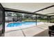 The screened-in pool area features a pool with an attached spa and lots of room for seating at 3802 Cloverhill Ct, Brandon, FL 33511