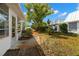 Exterior view of the backyard with beautiful landscaping and a walkway at 4227 Glissade Dr, New Port Richey, FL 34652