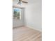 Cozy bedroom with laminate floors, a ceiling fan, and a bright window at 4227 Glissade Dr, New Port Richey, FL 34652