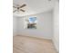 Bedroom with neutral walls and laminate floors, and a window with natural light at 4227 Glissade Dr, New Port Richey, FL 34652