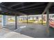 A large covered carport offers ample parking space, with a view of charming nearby homes and landscaping at 4227 Glissade Dr, New Port Richey, FL 34652