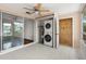 Florida room with tile flooring and a closet featuring a stacked washer and dryer at 4227 Glissade Dr, New Port Richey, FL 34652
