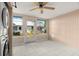 Bright Florida room featuring tile floors, a ceiling fan, and lots of natural light at 4227 Glissade Dr, New Port Richey, FL 34652