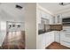 Efficiently designed kitchen with a modern open concept and direct access to living area and outdoor screened patio at 4227 Glissade Dr, New Port Richey, FL 34652