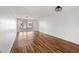 Expansive living area with beautiful laminate wood flooring and sliding doors to a screened outdoor patio at 4227 Glissade Dr, New Port Richey, FL 34652