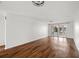 Bright living room featuring hardwood floors and sliding glass doors to an enclosed porch at 4227 Glissade Dr, New Port Richey, FL 34652