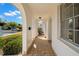 Covered porch with a tiled floor and elegant arches offers a welcoming entrance and protection from the elements at 4227 Glissade Dr, New Port Richey, FL 34652
