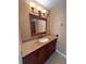 Bathroom vanity featuring a granite countertop, dark wood cabinet, and decorative lighting at 4624 W North B St, Tampa, FL 33609