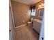 The bathroom has tiled floors and walls, toilet, vanity with sink, mirror, lighting and window at 4624 W North B St, Tampa, FL 33609