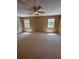 The bedroom has beige walls, carpet, a ceiling fan and two windows at 4624 W North B St, Tampa, FL 33609