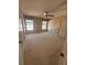 The bedroom has beige walls, carpet, a ceiling fan, two windows and three closets at 4624 W North B St, Tampa, FL 33609