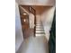 Entryway with staircase featuring carpeted steps and wood banister at 4624 W North B St, Tampa, FL 33609