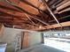 Interior view of the garage looking towards the car port, exposed beams and cabinetry at 4624 W North B St, Tampa, FL 33609
