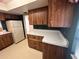 Kitchen featuring dark green walls, wood cabinets, and spacious countertops for meal preparation at 4624 W North B St, Tampa, FL 33609