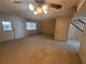 Large living room with carpet, a ceiling fan, and multiple entry points for easy access at 4624 W North B St, Tampa, FL 33609