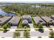 Aerial shot of the neighborhood highlighting a lake view, lush greenery, and well-maintained homes at 4777 Ballantrae Blvd, Land O Lakes, FL 34638