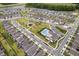 Aerial view of a modern community with pool, playground, sidewalks, green space and well-maintained landscaping at 4777 Ballantrae Blvd, Land O Lakes, FL 34638